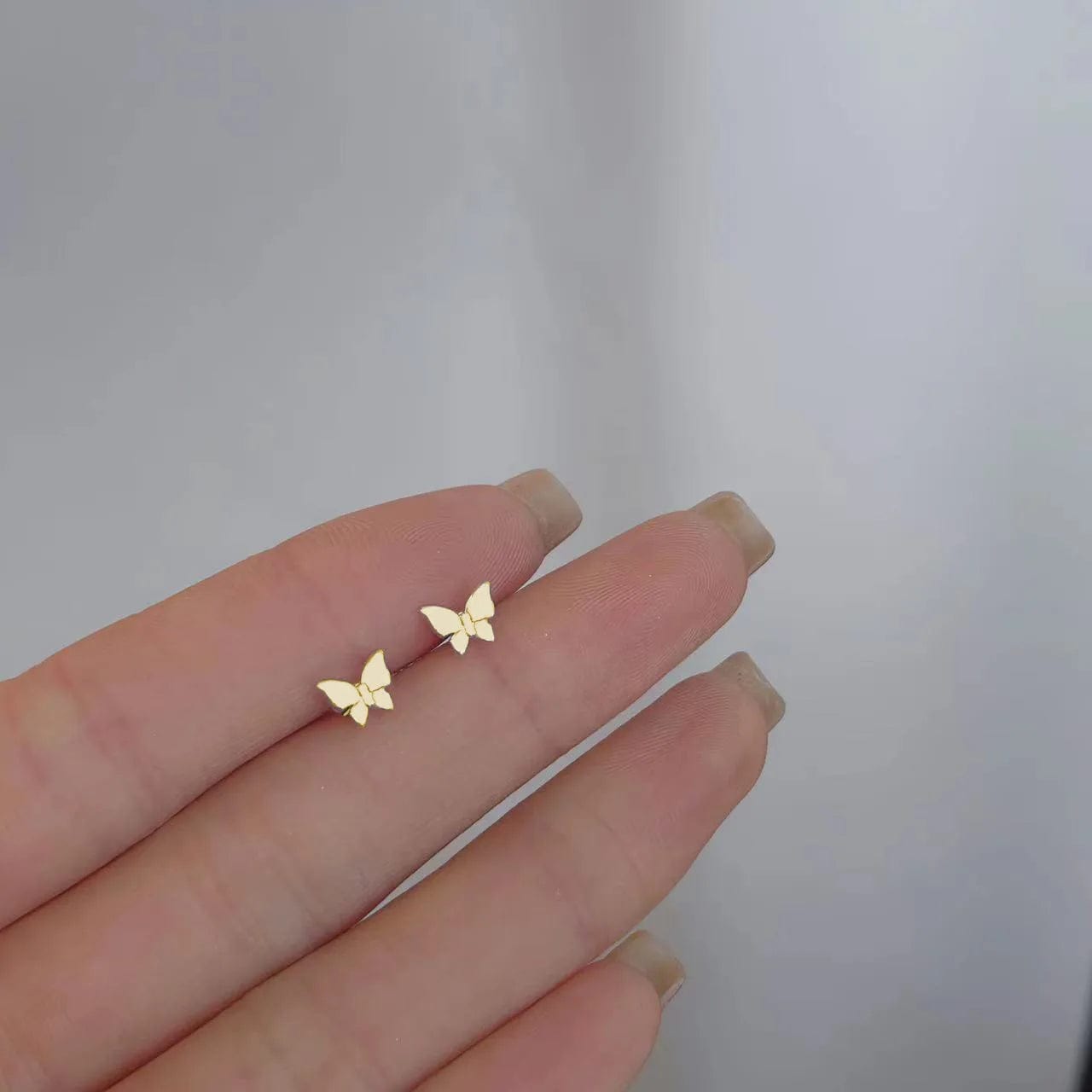 butterfly stud earrings in gold